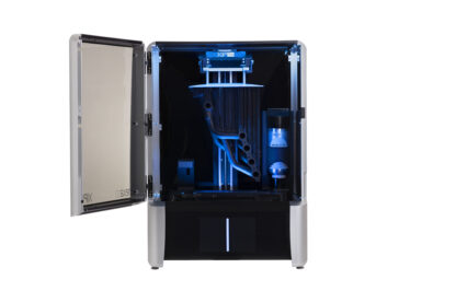 A photo of the XiP Pro 3D printer from Nexa3D with open door.